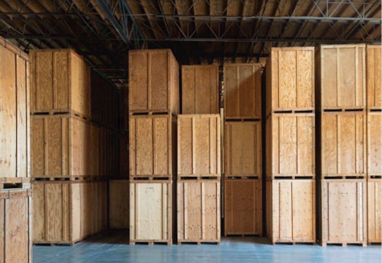 A warehouse filled with wooden boxes stacked on top of each other.